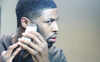 Philly's best barber, Rome, of Photo Finish, attempts the shape-up haircut on himself. (Screenshot/YouTube)